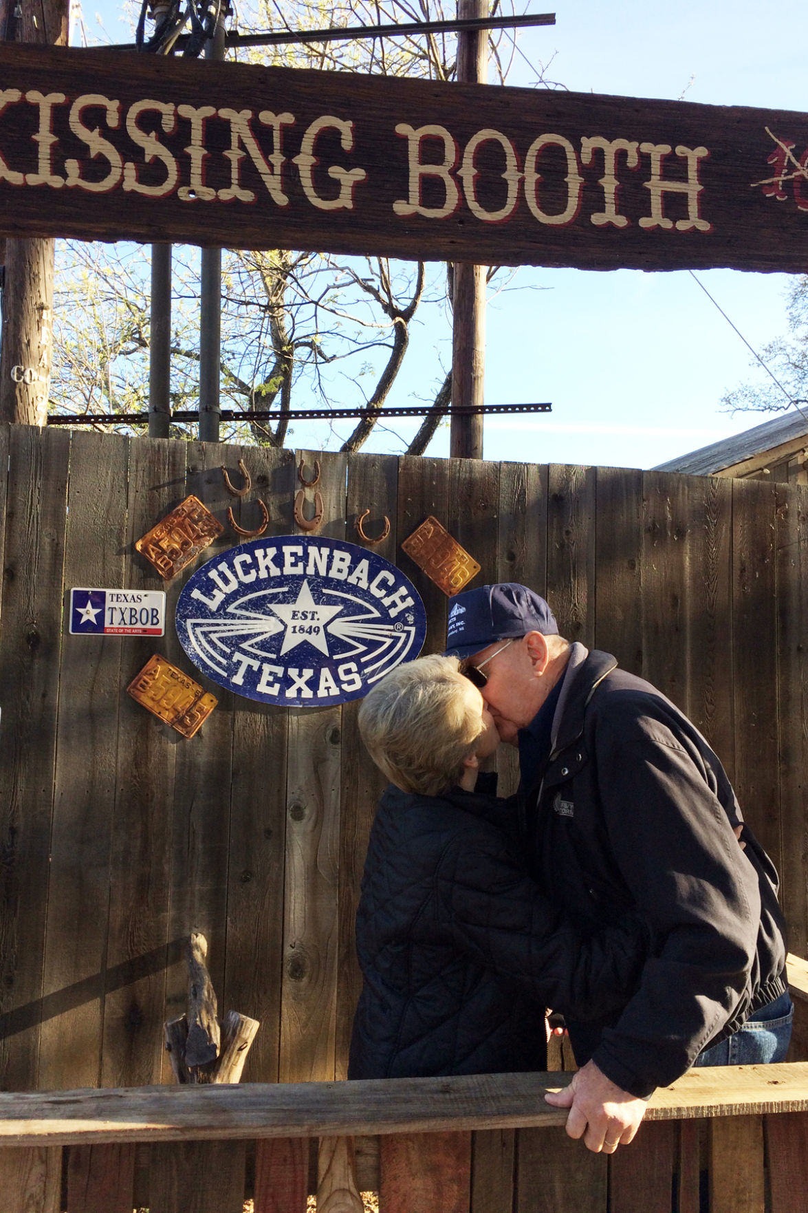 162 Wanda and Doug Peterson in the kissing booth at Luckenbach, Texas.JPG
